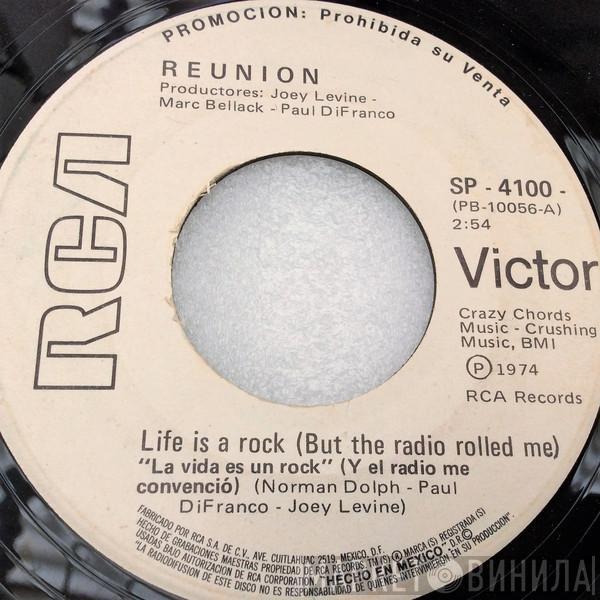  Reunion   - Life Is A Rock (But The Radio Rolled Me) = La Vida Es Un Rock (Y El Radio Me Convenció)